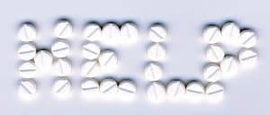 Pills layed out to spell "help"