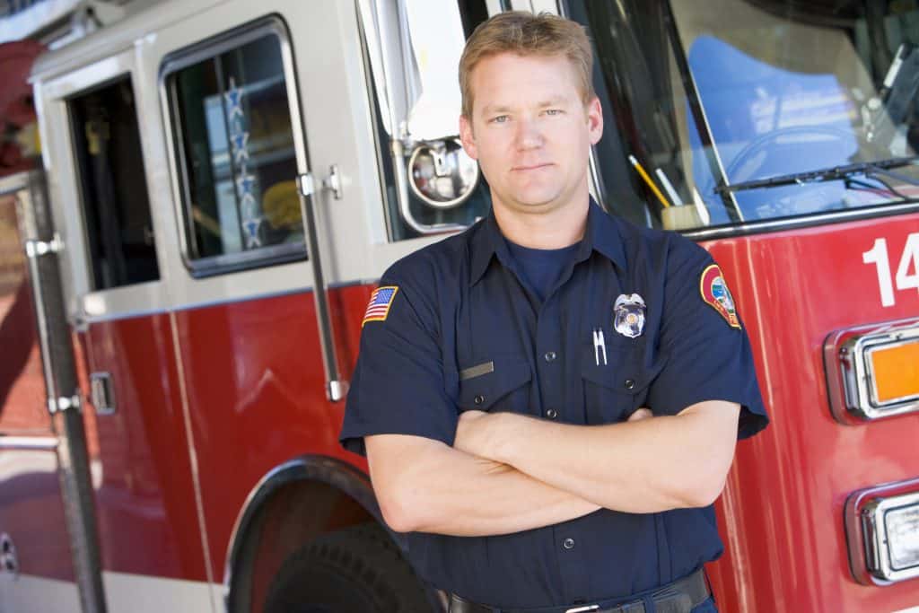 Firefighter standing next to a fire truck