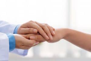 Doctor holding patient's hand