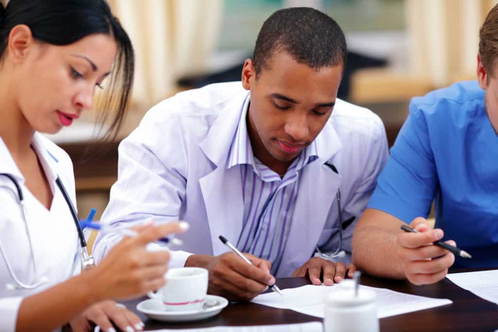 Doctors filling out forms