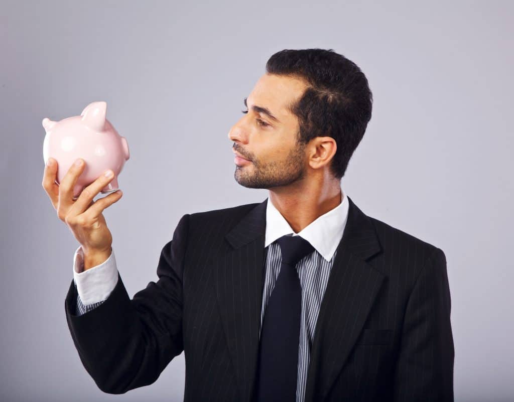 Person looking at a piggy bank