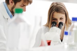 Doctor looking through a microscope