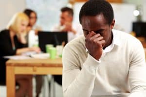 Person holding head with headache