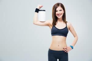 Person holding a canister of powdered protien