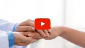 Doctor holding patient's hand
