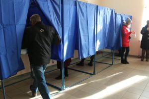 Image of person entering a voting booth