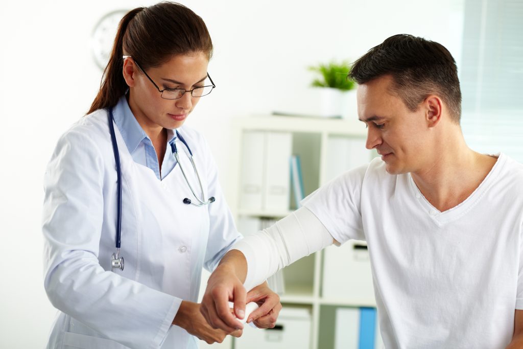 Doctor bandaging arm