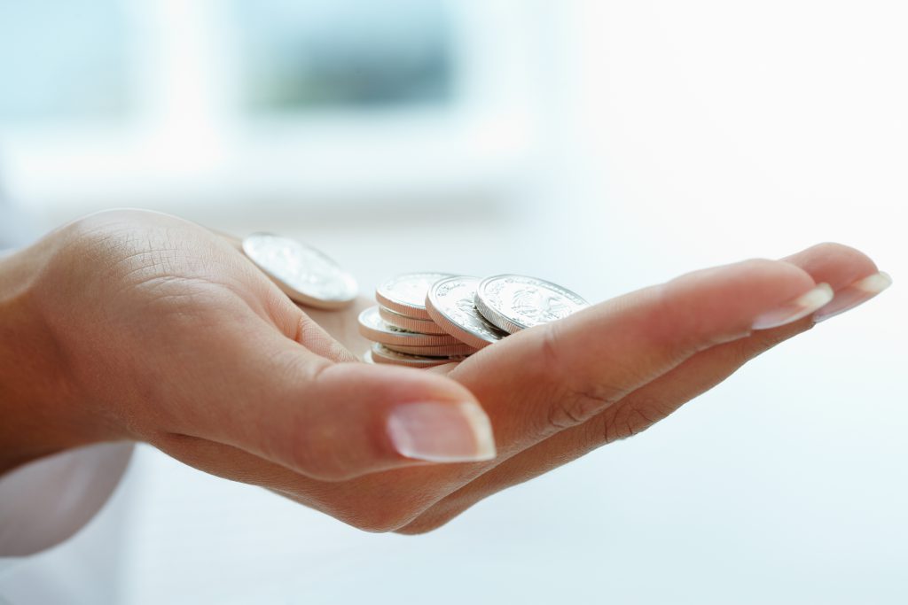 Image of hand holding coins