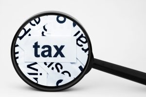 Tax under magnifying glass