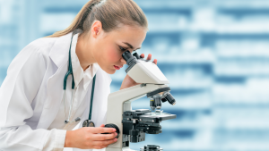Doctor looking through a microscope