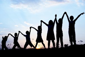 Kids holding hands with arms raised
