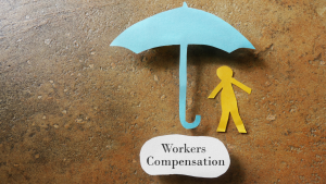 Paper doll standing under paper umbrella