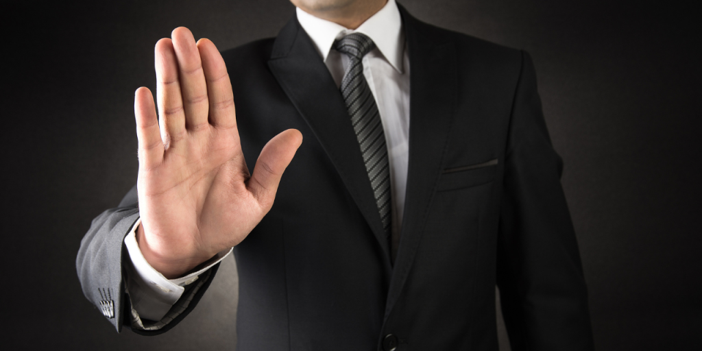 Person holding out their hand to signal "stop"