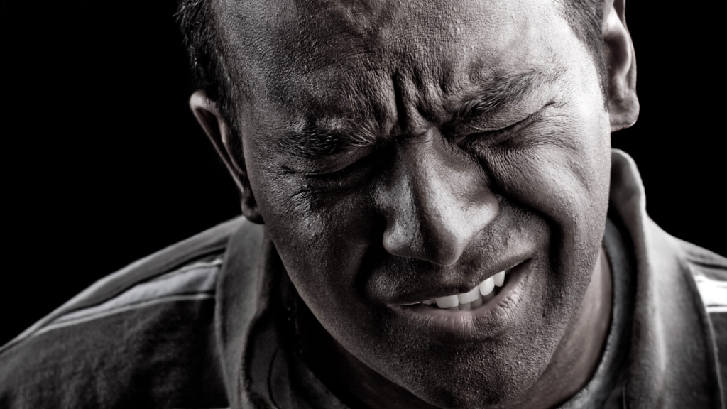 Person with a pained look on their face
