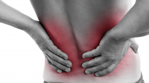 Person rubbing lower back