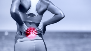Person rubbing lower back