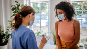 Doctor and patient wearing face coverings