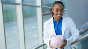 Doctor holding a piggy bank