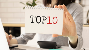 Person holding "Top 10" sign