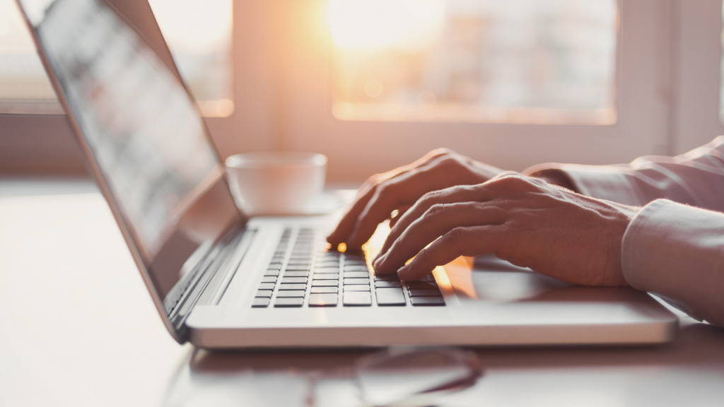 Hands typing on a keyboard