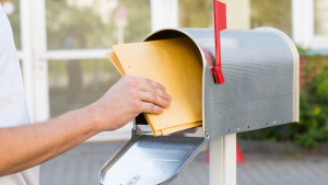 Person pulling mail from mail box