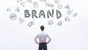 Person looking at "brand" written on a wall