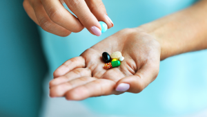 A hand holding vitamins