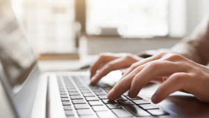Hands typing on a keyboard