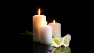 3 candles with a peace lilly