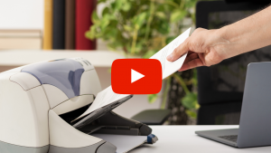 Person pulling paper off of printer