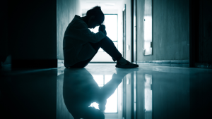 Person sitting in hallway