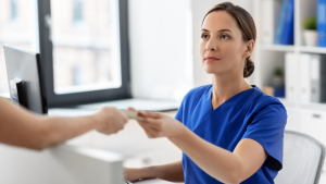 Front Desk worker receiving payment