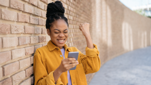 Person celebrating while looking at phone