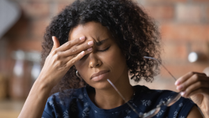 Person with headache rubbing head.
