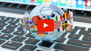 Globe with international flags in speach bubbles in front of a computer
