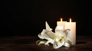 2 lit candles and a peace lilly
