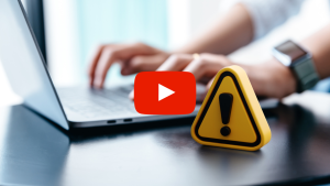 Warning sign next to a person using a computer