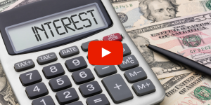 Calculator laying on a pile of money