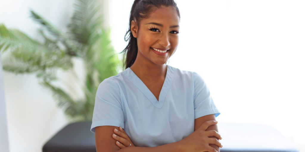 Chiropractic physician standing in front of an adjusting table