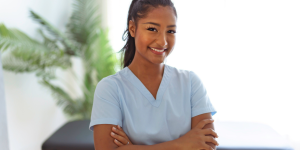 Chiropractic physician standing in front of an adjusting table