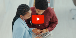 Two people reviewing a website