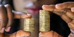 Person holding two stacks of coins