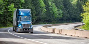 Tractor-trailer driving down the road