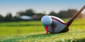 Golf ball on a tee with a driver