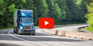 Tractor Trailer driving down the road.