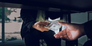 People passing money under the table