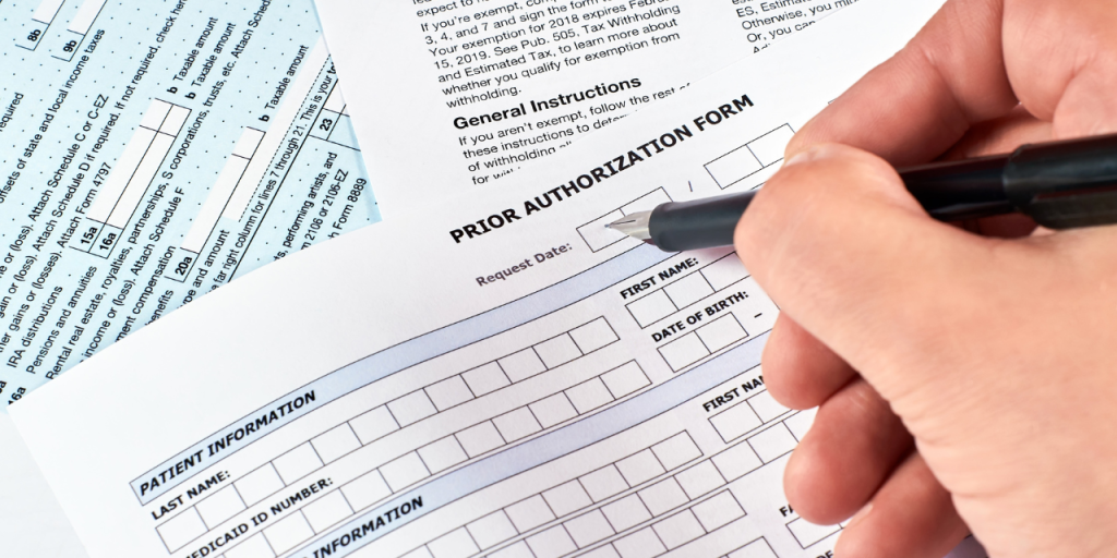 Person filling out prior authorization form