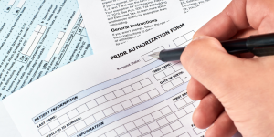 Person filling out prior authorization form