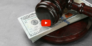 Gavel laying on a stack of money