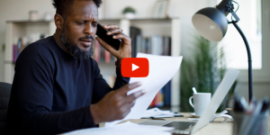 Person reviewing documents while talking on the phone